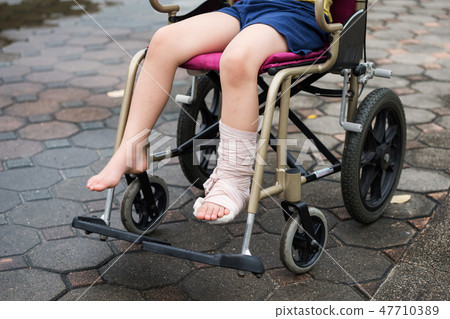 Leg broken boy sit on wheelchair Leg broken boy sit on wheelchair 47710389
