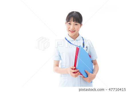 A young smiling nurse wearing nurse clothes A young smiling nurse wearing nurse clothes 47710415