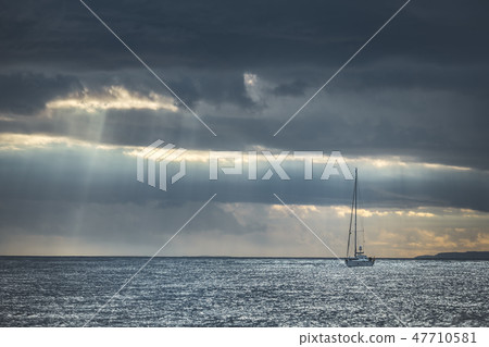 Rainy sky above the yacht in the sea. Ireland. Rainy sky above the yacht in the sea. Ireland. 47710581