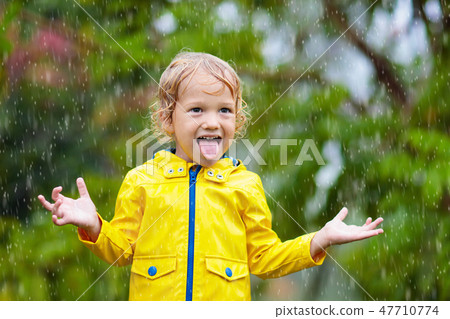 Kids play in autumn rain. Child on rainy day. Kids play in autumn rain. Child on rainy day. 47710774