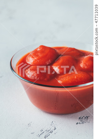 Bowl of canned tomatoes Bowl of canned tomatoes 47711039