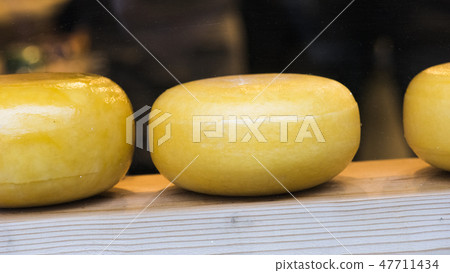 Cheese on the market behind the glass counter Cheese on the market behind the glass counter 47711434