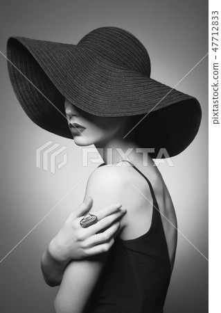 portrait of young lady with black hat and evening dress 47712833