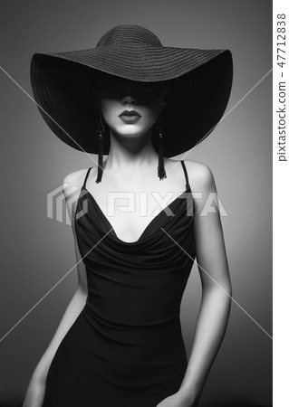 portrait of young lady with black hat and evening dress 47712838