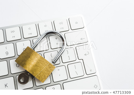 Background image of metal lock on keyboard 47713309
