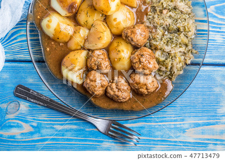 Homemade fried meatballs served with potatoes Homemade fried meatballs served with potatoes 47713479