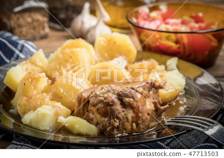 Stewed pork meat served with potatoes Stewed pork meat served with potatoes 47713503