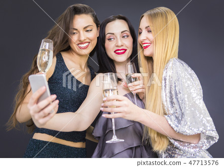 Three young woman having fun and making selfie 47713576