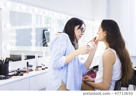 Young pretty smilling woman with glas of champagne 47713650