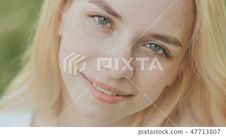 Close-up face of a smiling 19 year old blonde girl. Close-up face of a smiling 19 year old blonde girl. 47713807