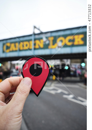 man with a red marker in Candem Lock, London, UK 47713832