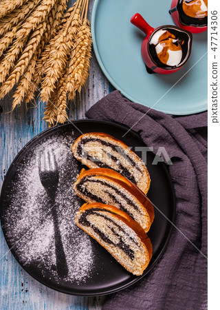 Poppy seed strudel on dark plate Poppy seed strudel on dark plate 47714306