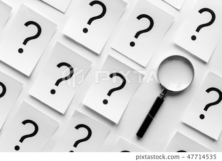 Diagonally orientated question marks and magnifier 47714535
