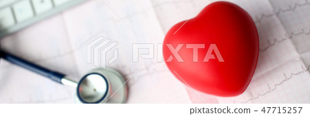 Medical stethoscope head and red toy heart 47715257