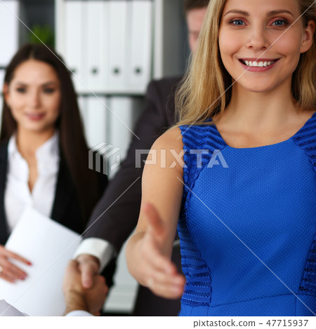 Woman in suit give hand as hello in office 47715937