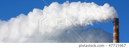White smoke comes from pipes against blue sky 47715967