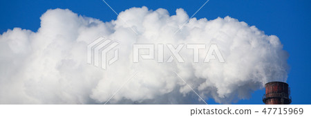 White smoke comes from pipes against blue sky White smoke comes from pipes against blue sky 47715969