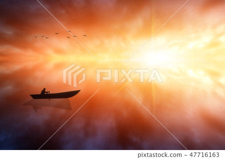 Boat With a Man on the Sea Water. Fiery Sea Sunset 47716163