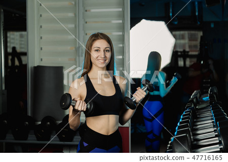 Young and beautiful woman working out with Young and beautiful woman working out with 47716165