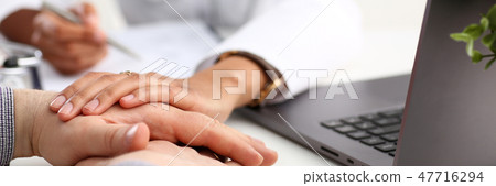 Friendly female doctor hold male patient 47716294