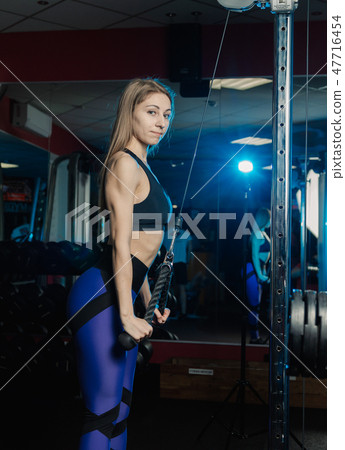 Active beautiful fitness model girl trains triceps Active beautiful fitness model girl trains triceps 47716454