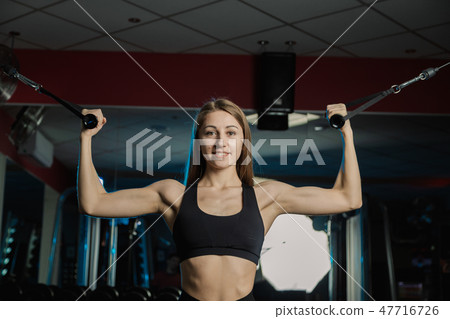 Active beautiful fitness model girl trains biceps Active beautiful fitness model girl trains biceps 47716726
