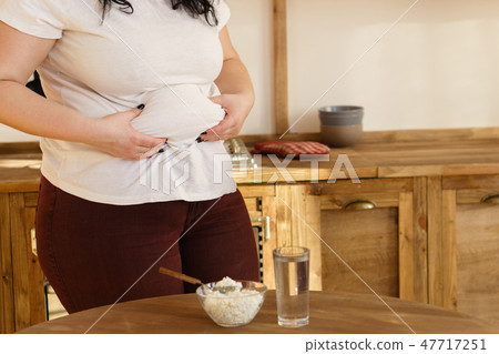 overweight woman hands touching belly fat overweight woman hands touching belly fat 47717251