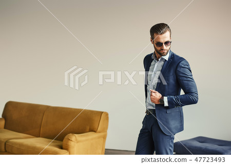 Portrait of stylish and attractive bearded businessman in sunglasses and classic suit. Portrait of stylish and attractive bearded businessman in sunglasses and classic suit. 47723493