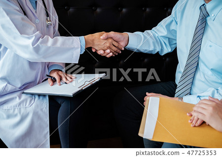 Patient listening intently to a male doctor explai 47725353