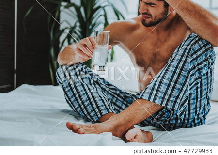 Guy suffering from headache in the morning Guy suffering from headache in the morning 47729933
