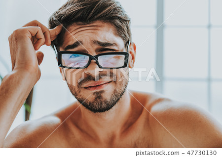 Upset young guy refusing to wake up early 47730130