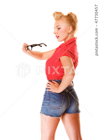 beautiful girl retro hairstyle holds glasses isolated 47730457