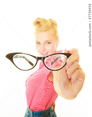 Blonde pin up girl holding retro glasses 47730458