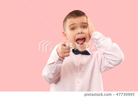 The young attractive teen boy looking suprised isolated on pink The young attractive teen boy looking suprised isolated on pink 47730995