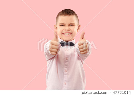 The happy teen boy standing and smiling against pink background. The happy teen boy standing and smiling against pink background. 47731014