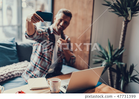 Charming man making selfie in coffee house Charming man making selfie in coffee house 47731399