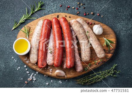 Assorted fresh sausages with thyme. 47731581