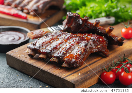 Closeup of pork ribs grilled with BBQ sauce. Closeup of pork ribs grilled with BBQ sauce. 47731585