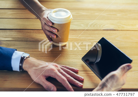 Barista serves coffee to a man. Barista serves coffee to a man. 47731797