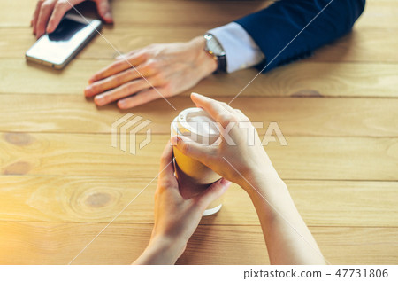 Barista serves coffee to a man. Barista serves coffee to a man. 47731806