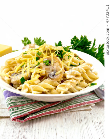 Fusilli with mushrooms and cream on napkin 47732411