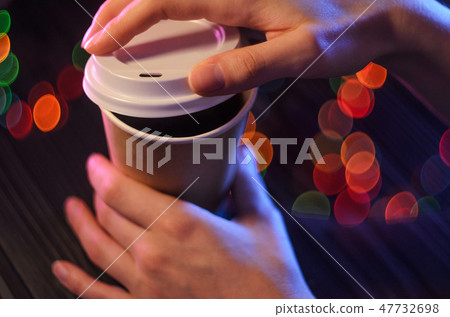 A cup of takeaway coffee on the table. Bokeh light 47732698