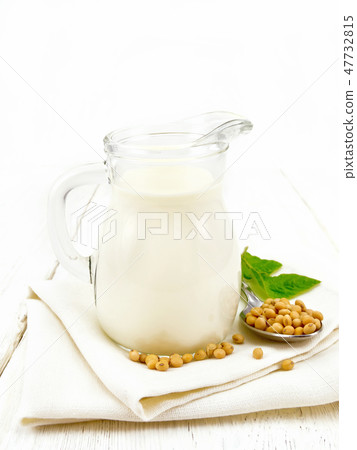 Milk soy in jug with leaf on light board 47732815