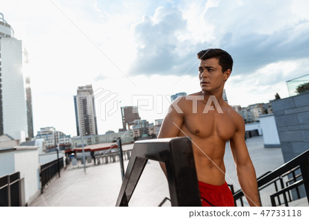 Young serious athlete is looking away outdoor 47733118