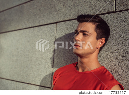 Pensive male locating near building during rest Pensive male locating near building during rest 47733237