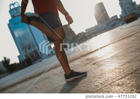 Male hand making physical exercise with leg Male hand making physical exercise with leg 47733282