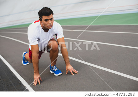 Focused young man is making workout outdoor Focused young man is making workout outdoor 47733298