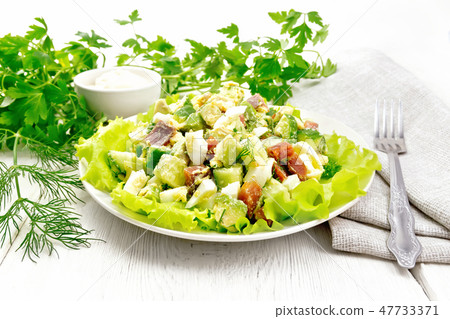 Salad of salmon and avocado on light board Salad of salmon and avocado on light board 47733371