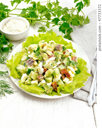 Salad of salmon and avocado on light wooden board Salad of salmon and avocado on light wooden board 47733372
