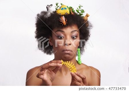 Shocked ethnic lady look on fish skeleton earring 47733470